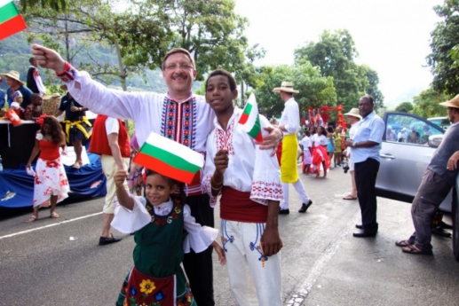 Maxim Behar, Martina and Steven dressed in Bulgarian costumes, carrying Bulgarian flags, at the 2014 Seychelles International Carnival of Victoria